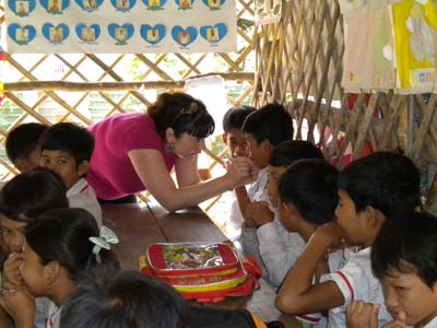 SFSU student talking to camboian children