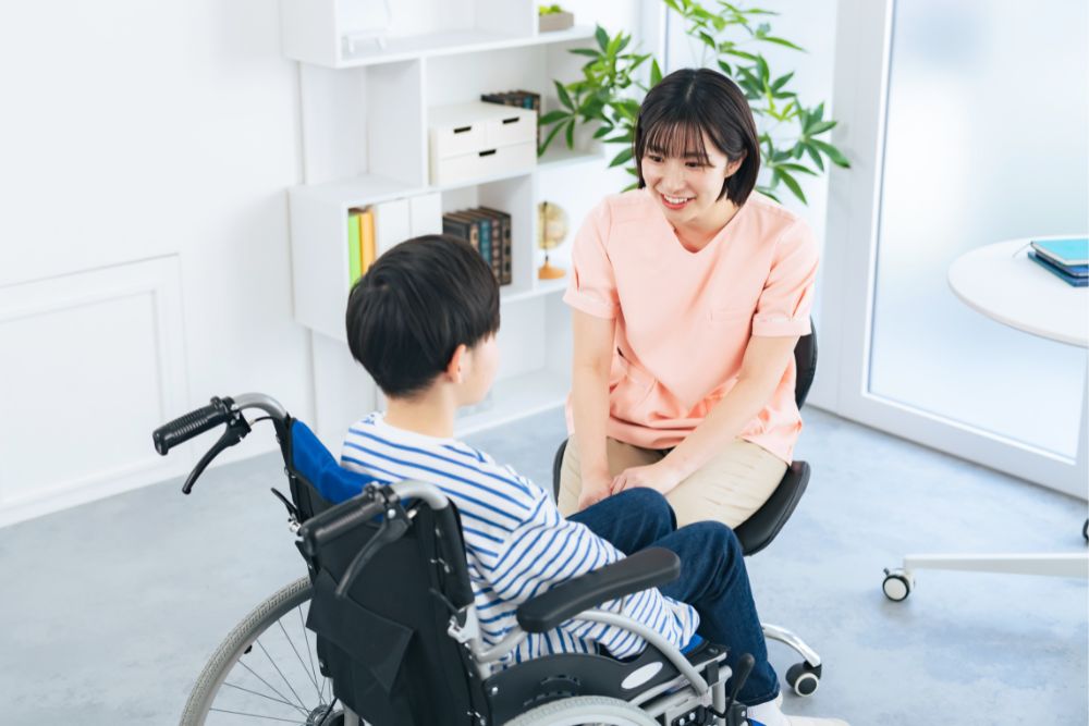 School nurse talks to student in a wheelchair