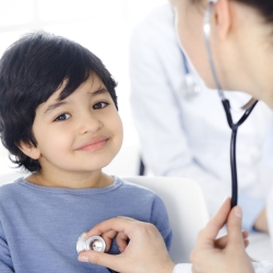 School nurse listens to child's heart