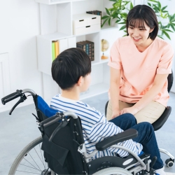 School nurse talks with student in a wheelchair